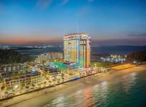 a tall building on the beach at night at Flamingo Hai Tien Beach Resort in Thanh Hóa