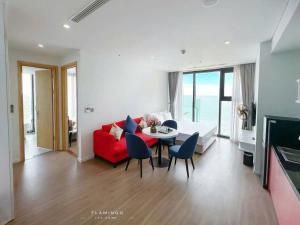 a living room with a red couch and a table at Flamingo Hai Tien Beach Resort in Thanh Hóa