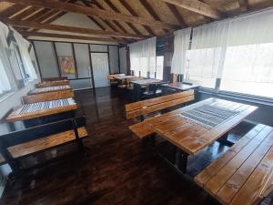 an empty classroom with wooden tables and benches at MORLAK - Guest House - Restaurant - Gated parking in Polača +60 photos