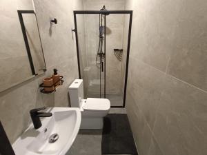 a bathroom with a shower and a toilet and a sink at MORLAK - Guest House - Restaurant - Gated parking in Polača