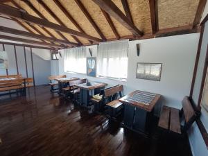 an empty room with wooden tables and chairs at MORLAK - Guest House - Restaurant - Gated parking in Polača
