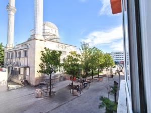 a view from a window of a building with trees and a street at Edion Center Apartment in Shkodër