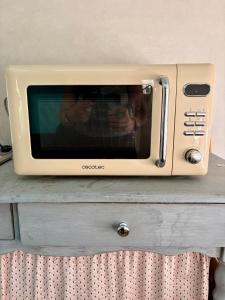 a microwave sitting on top of a table at Salève Glamping in Archamps