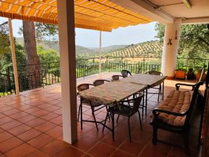 a table and chairs on a patio with a view at Casa Terra in Hontanar