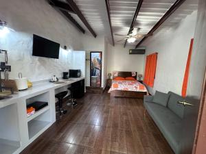 a room with a bed and a desk with a couch at Don Lioni in El Valle de Antón