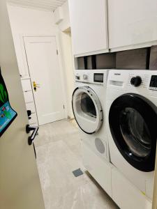 a laundry room with a washer and dryer at Langafit Guest house in Garðabær