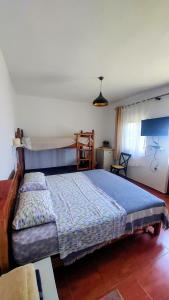 a bedroom with a bed with a blue comforter at Rustic Tale Guesthouse in Tale