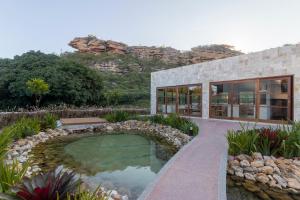 a house with a swimming pool in a garden at Diamantino Residence - Barro in Mucugê
