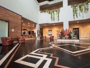 a lobby with chairs and a table in a building at ibis Styles Presidente Prudente Portal D'Oeste in Presidente Prudente +175 photos