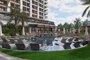 a swimming pool with lounge chairs and a hotel at Almaris Resort in Alanya