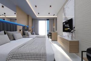 a bedroom with a bed and a tv on a wall at Almaris Resort in Alanya