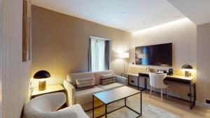 a living room with a couch and a table at Hotel Mezquita Center in Córdoba