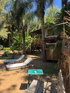 a playground with slides and a table and trees at Cabañas Allende Delta in Tigre