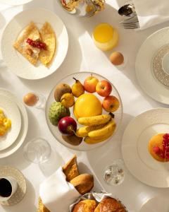 a white table with plates of food on it at Maison Bauchart in Paris