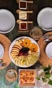 a table with a plate of fruit and other food at Cabañas Allende Delta in Tigre