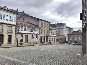 an empty street in a city with buildings at Ribeira Sacra Ledicia in Chantada