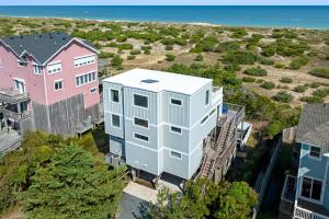 an aerial view of a building next to houses at Crabcake Village OBX in Salvo