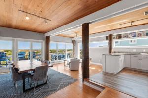 a kitchen and dining room with a table and chairs at Crabcake Village OBX in Salvo