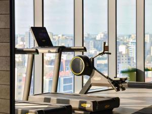 a gym with a treadmill and a laptop on it at Novotel Abidjan Marcory in Abidjan