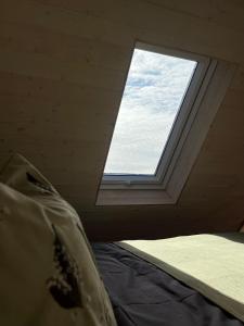 a window in a room with a bed in front of it at Uduaasa Minimaja in Urge