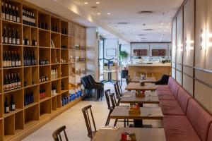 a restaurant with tables and shelves of wine bottles at Onyx Studio Apartment in Cape Town