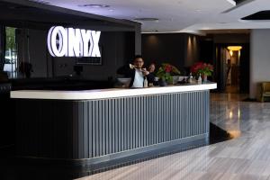 a man and a woman standing at a bar in a lobby at Onyx Studio Apartment in Cape Town +16 photos