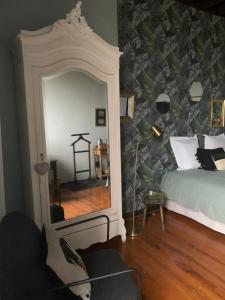 a bedroom with a large mirror and a bed at L'Horizon de Marianne in Montagnac-sur-Auvignon +15 photos