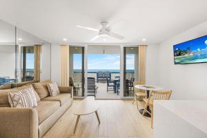 a living room with a couch and a table at Apollo 207 in Marco Island