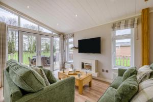 a living room with two couches and a tv at Primrose 2 bed-No Pets-Daisy in Eye