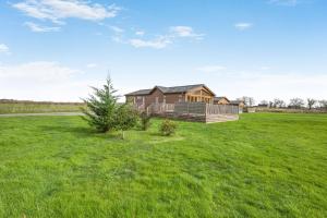 a large grassy field with a house at Primrose 2 bed-No Pets-Daisy in Eye