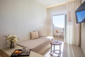 a hotel room with a bed and a balcony at Charaki Rest Point in Haraki