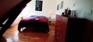 a bedroom with a bed and a dresser at Chez ISA chambre chez l'habitant Léa in Montlouis-sur-Loire