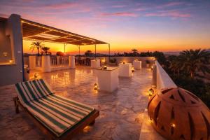 a patio with a bench on top of a house at Ali Baba Hotel in Luxor