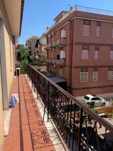 a balcony of a building with graffiti on the sidewalk at La casa di Amina in Rome