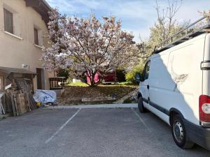 a van parked in a parking lot next to a building at Salève Glamping in Archamps