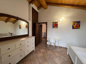 a bedroom with a dresser and a table and a chair at Mountain Chalet Ca' dal Ghiru by Villa Bernardino Galliari in Sagliano Micca +40 photos