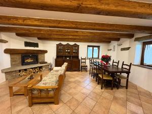 a living room with a table and a fireplace at Mountain Chalet Ca' dal Ghiru by Villa Bernardino Galliari in Sagliano Micca