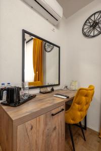 a mirror on top of a wooden desk with a chair at Hotel Domestika in Skopje +56 photos