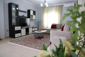 a living room with a couch and a table at Apartment Nikolas Berat in Berat