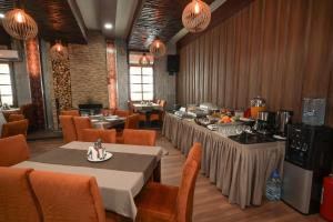 a restaurant with tables and chairs in a room at Hotel Domestika in Skopje