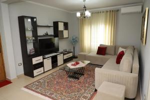 a living room with a couch and a tv at Apartment Nikolas Berat in Berat