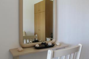 a mirror sitting on top of a dresser in a room at Vakis Apartments 2 in Romanón