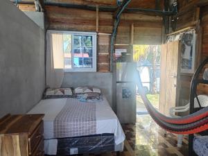 a bedroom with a bed and a hammock in it at Ranchito Cornejo in La Esmeralda