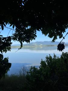 a view of a lake with mountains in the distance at Mato Verde Hospedaria - À beira da Lagoa - Praia do Rosa in Imbituba