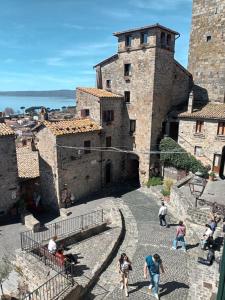 a group of people walking around a castle at Residenza Caterina in Bolsena