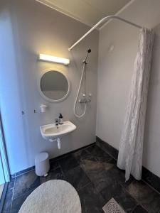 a bathroom with a sink and a shower at Lysbøen Bua in Ramberg +22 photos