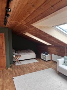 a attic room with a bed and a vaulted ceiling at 2 minute walk from ONS exhibiton area in Stavanger