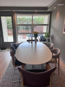 a dining room with a white table and chairs at 2 minute walk from ONS exhibiton area in Stavanger +16 photos