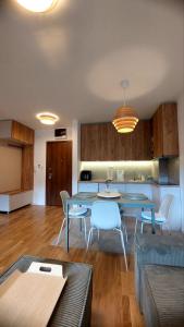 a kitchen and a living room with a table and chairs at My Life 19 - Green Hill in Soko Banja