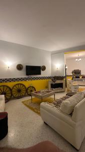 a living room with a couch and a flat screen tv at Dar morjana in Chott Meriem